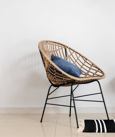 a chair with a cushion and a chair with a rug
