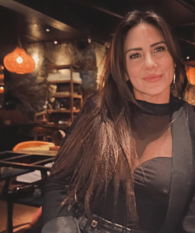 a woman in a black dress and a black jacket