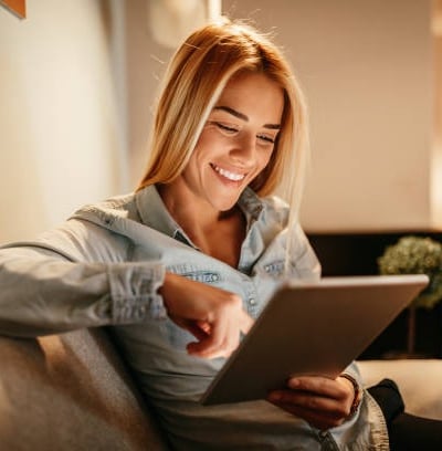 a woman sitting on a couch with a laptop