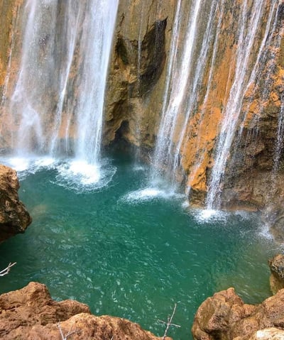 a waterfall in a canyon near a waterfall