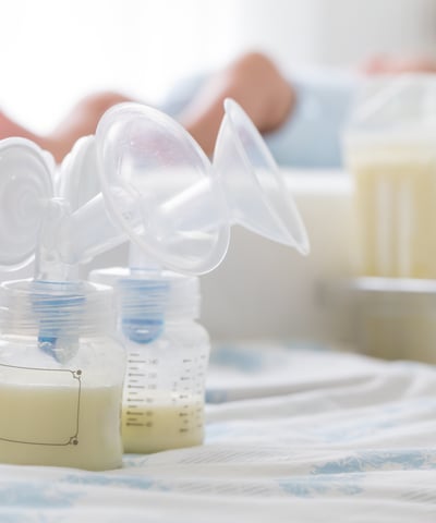 a baby bottle with a bottle of milk and a bottle of milk