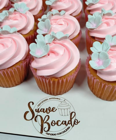 a bunch of cupcakes with pink frosting