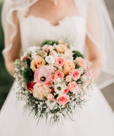 a bride in a wedding dress holding a bouquet