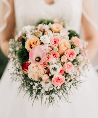 a bride in a wedding dress holding a bouquet