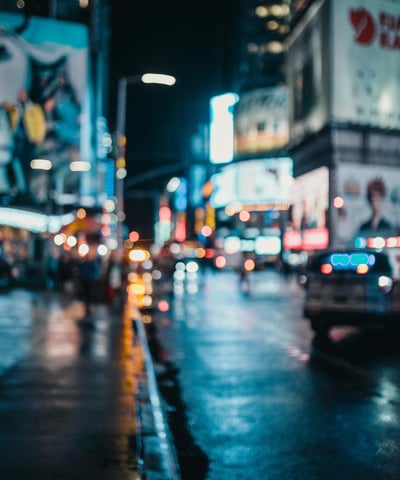 a city street scene with a car parked on the side of the road