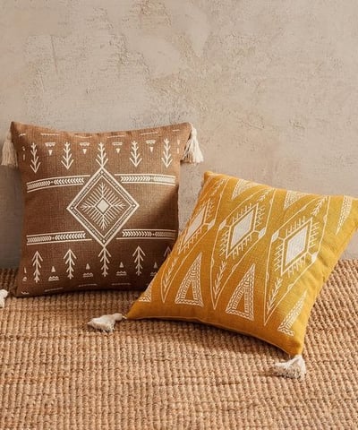 a pair of pillows with a brown and white pillow