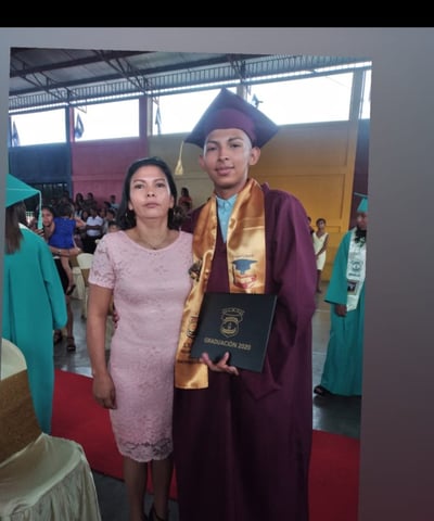 Angel, as scholarship student poses with his mother, Yelba at his high school graduation