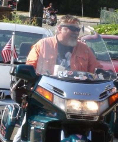 Happy biker riding motorcycle.