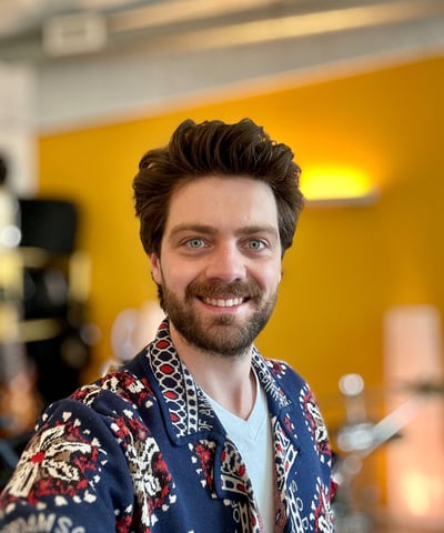 a man with a beard and a beard wearing a blue shirt