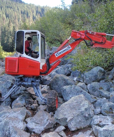 Compact spider hoe being used to construct trail into Joffre Lakes Park