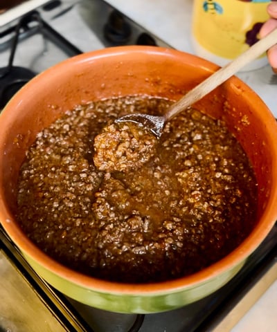 Alessandra Spisni cooking ragù Bolognese, a classic recipe from Emilia-Romagna cuisine.