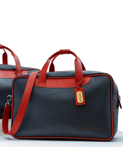 two bags of luggage with a red and blue one by heros leather