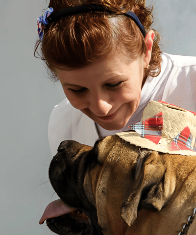 a woman in a hat and a dog wearing a hat