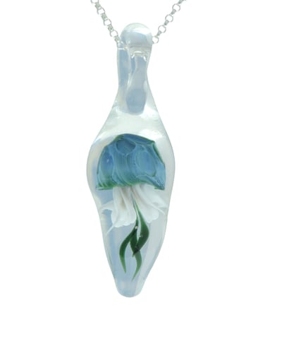 a blue jellyfish inside a clear glass pendant