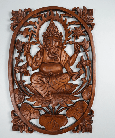 a wooden carving of a ganesha