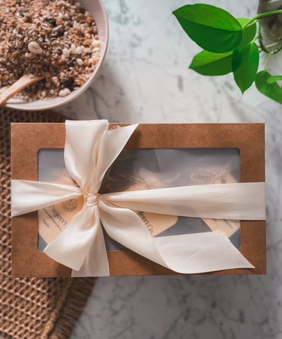 "Gift box of handcrafted Panjeeri granola tied with a decorative bow, perfect for wellness or gifs