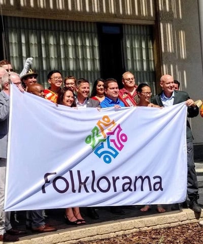 a group of people standing in front of a banner