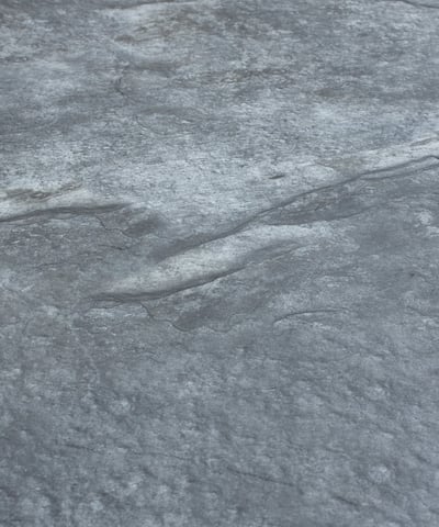 A soft stone slate featuring a unique black and gold veining pattern, ideal for elegant wall designs
