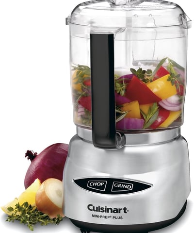 a food processor with a blender and vegetables