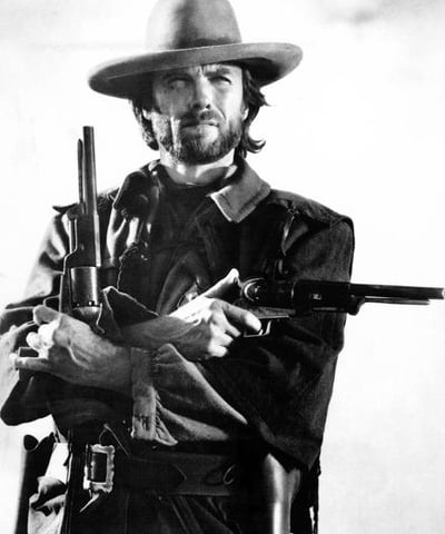 a man in a cowboy hat and a gun