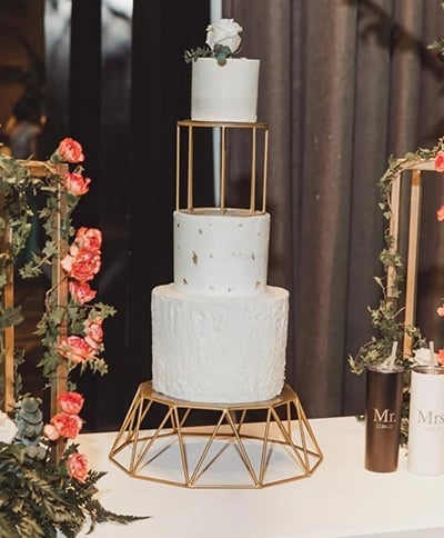 a cake with a gold frame and flowers