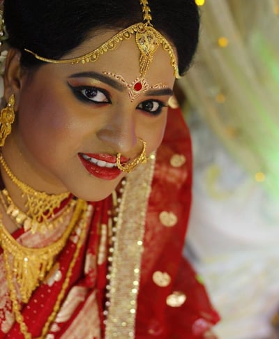 a woman in a red dress and gold jewelry