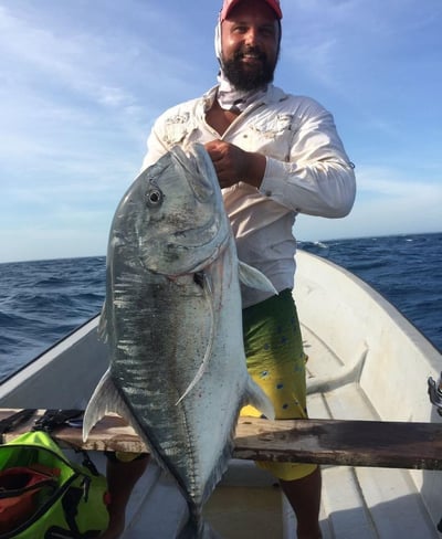 Latham Island Fishing Charters Zanzibar - Angler proudly holding a Giant Trevally