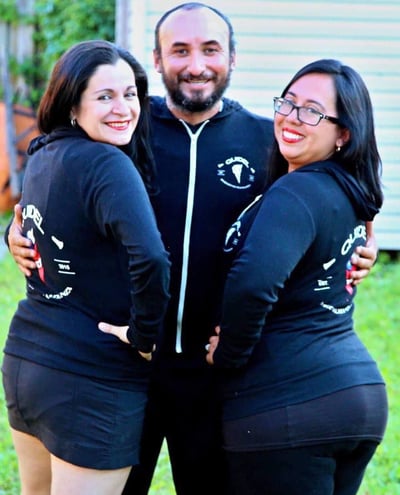 a man and woman in matching black outfits