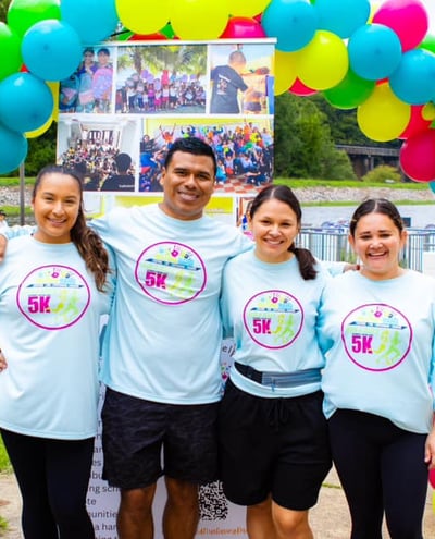 a group of people standing in front of a sign