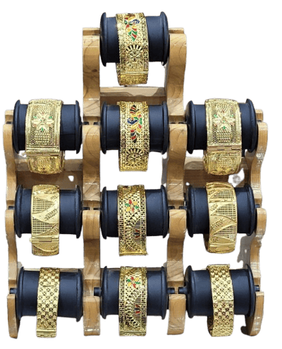 a display of gold and black bracelets with gold and black and white bracelets