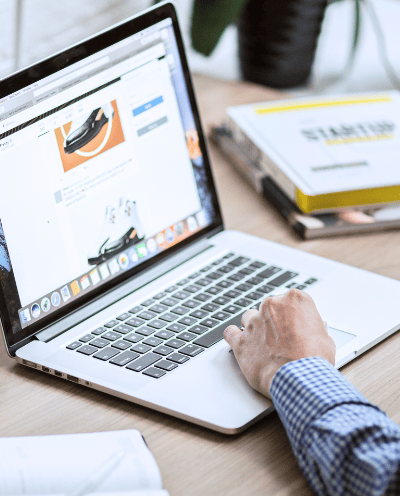 Image of a man at a desk with a laptop open to a website to symbolize website translation and localization services.