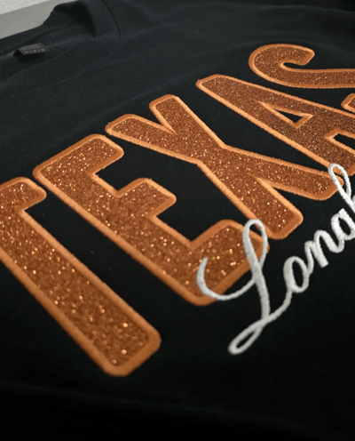 Custom black sweatshirt with glitter TEXAS appliqué and white script embroidery – personalized hoodi