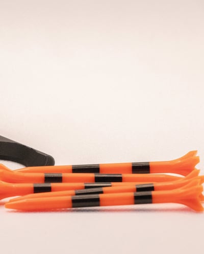 TeeZUP club attachment tee assist tool with three orange-striped tees