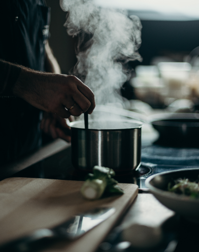 a person cooking Soup on a stove