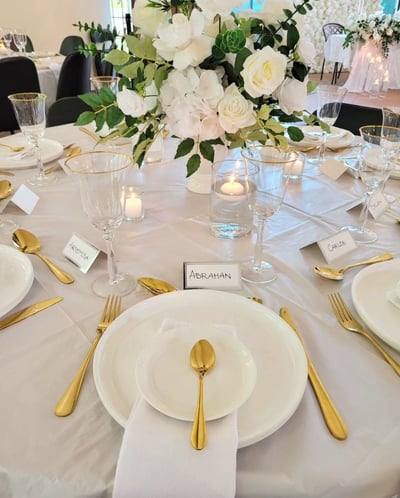 Gold Tableware with a floral centerpiece