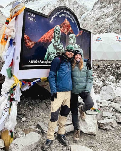 Manon and her Nepali guide in front of the Everest Base Camp sign, Nepal.