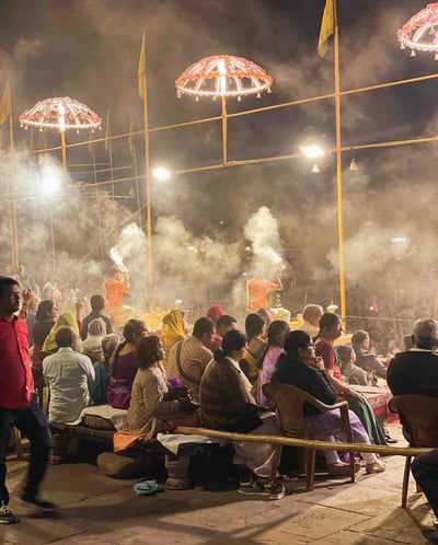 People taking part in a religious ceremony on the ghats of Varanasi, India.
