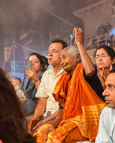 Portrait of an elderly Indian woman during a religious ceremony in Varanasi, India.