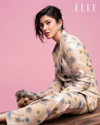 a woman sitting on a table with a dog