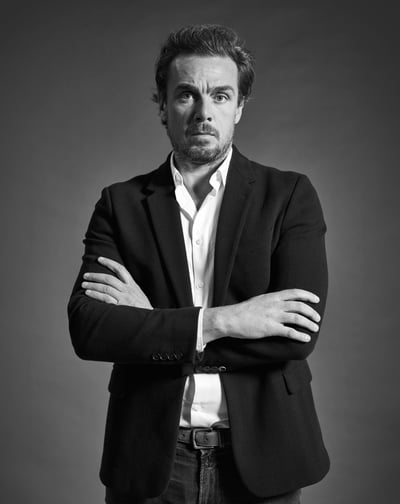 a man in a suit and tie is posing for a picture