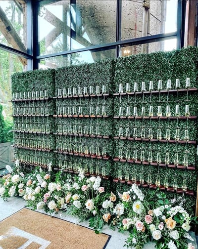 3 Champagne walls with flowers and greenery in the entrance of venue