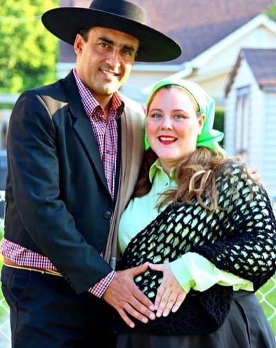 a man and woman in a Chilean hat and a black dress