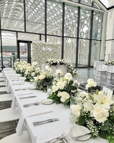 Wedding backdrop with white rose centerpieces 