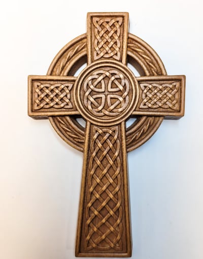 a cross - shaped celtic cross on a white wall