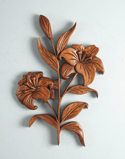 a decorative wooden carving of a lily flower