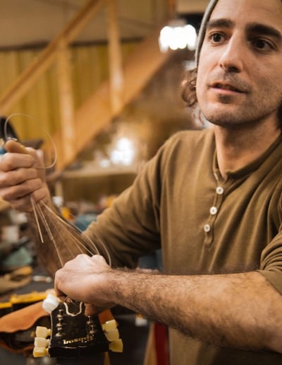 Izzy Lugo restringing a vintage Gibson guitar