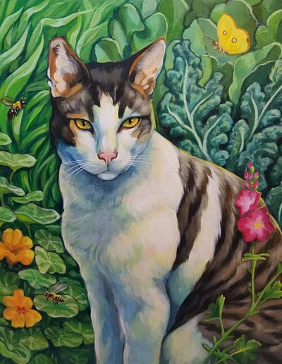 A brown and white cat sits in a garden surrounded by plants and flowers, bees and butterflies.