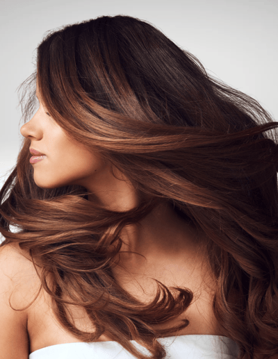 woman with thick, brunette hair and a Brazilian blowout 