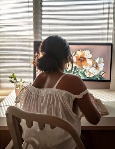 Black woman designing flower design on a computer