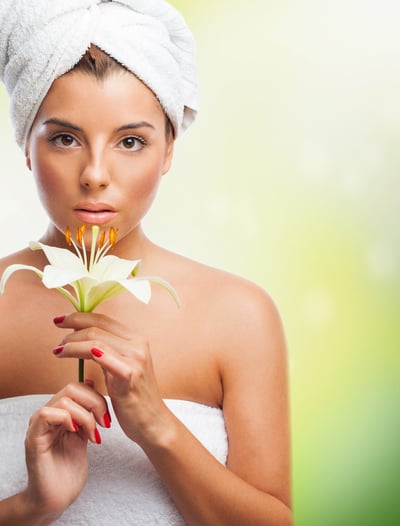 a woman wrapped in a towel with a flower